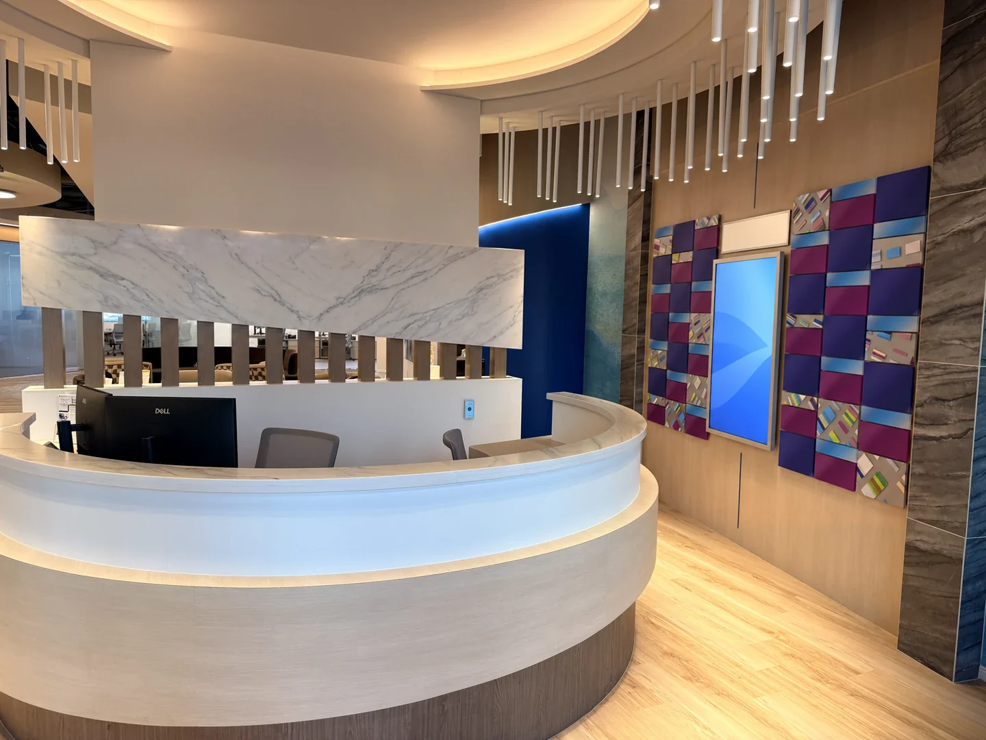 The entrance with a curved reception desk, marble panel and the donor recognition display.
