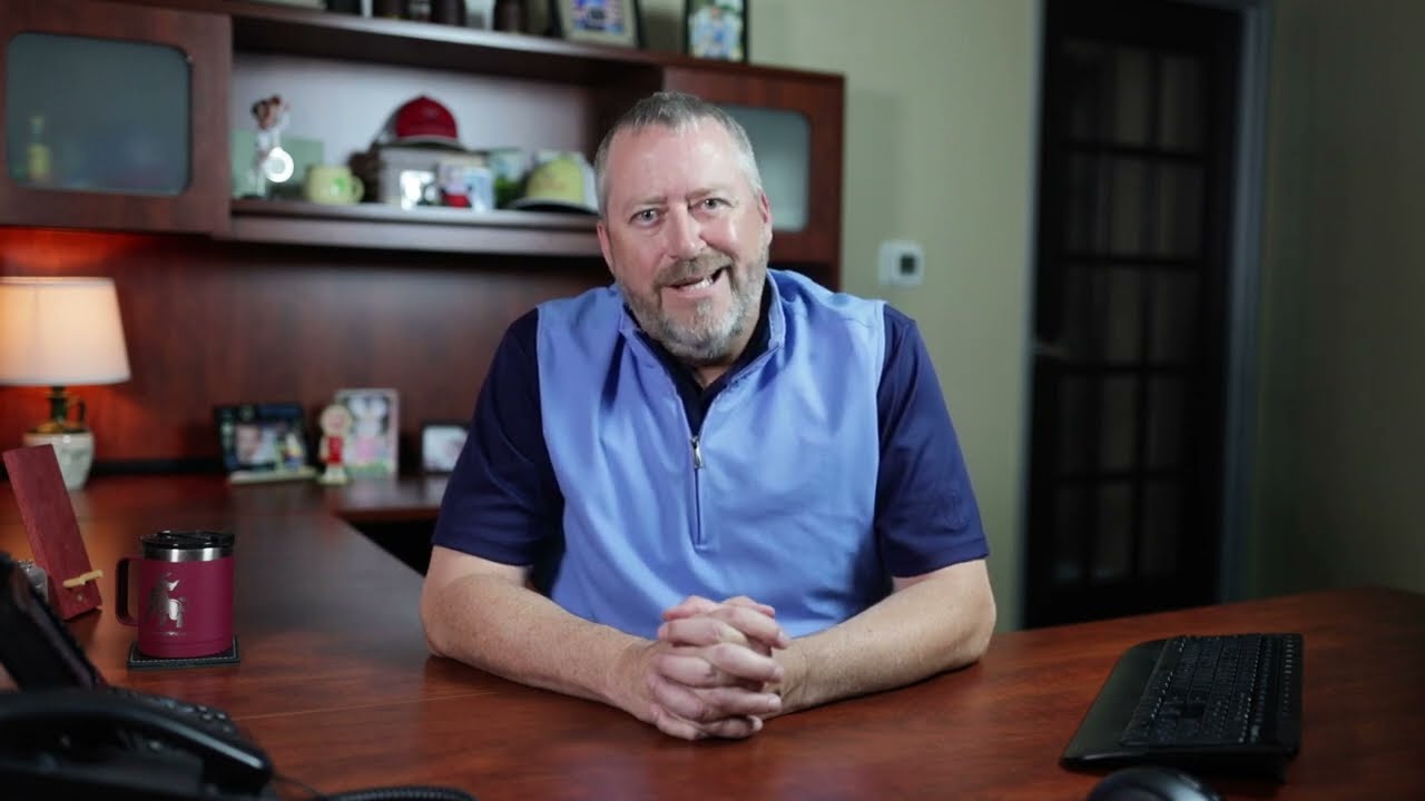 Aaron Cooper at his desk, ready to welcome you